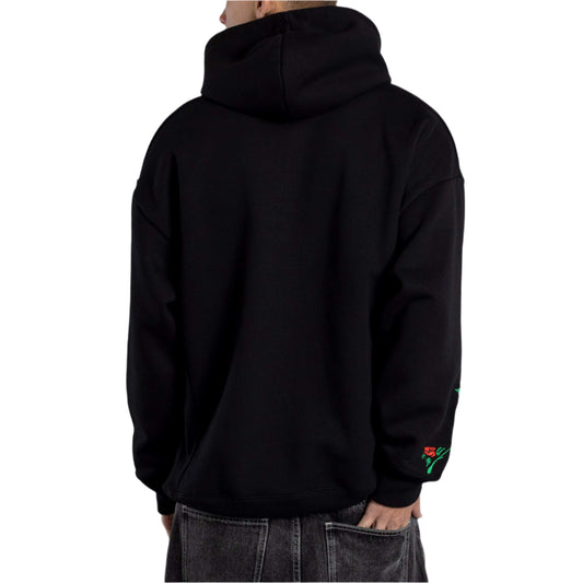 Person wearing a black hoodie with a gray background