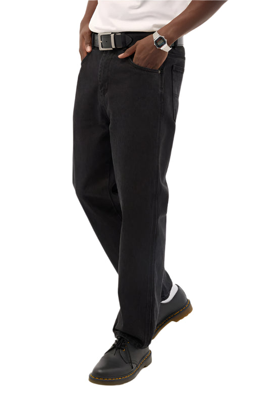 Person wearing black pants and black shoes on a white background
