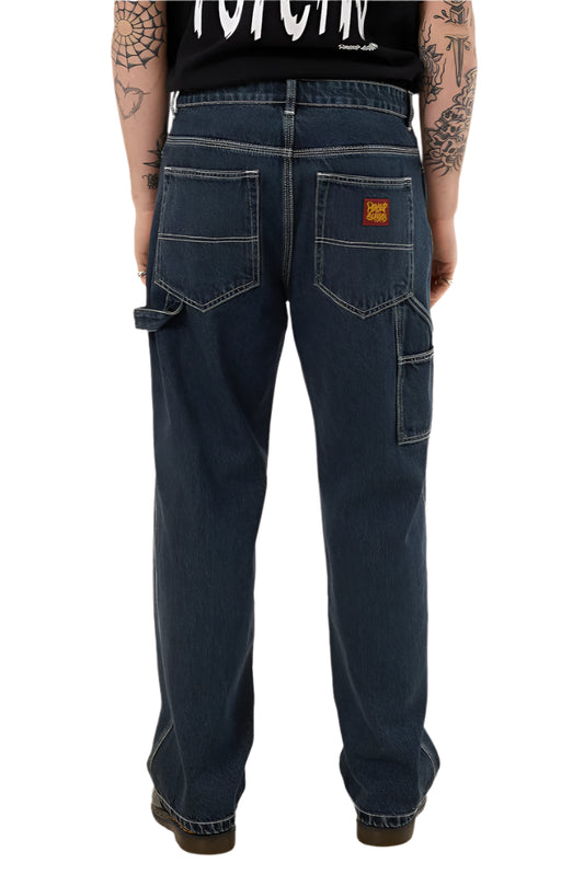 Person wearing dark blue jeans with a visible brand logo on a white background