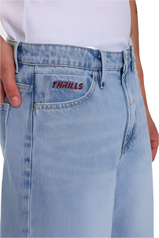 Light blue jeans with 'Thrills' embroidery on pocket against a white background