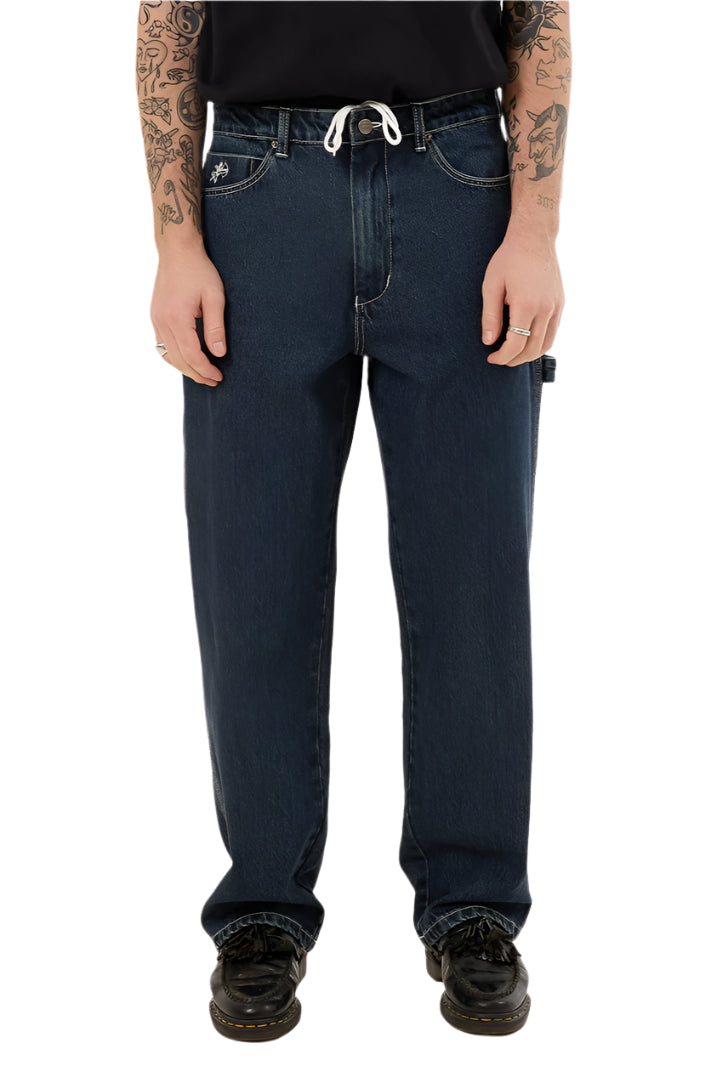 Person wearing dark blue jeans on a white background