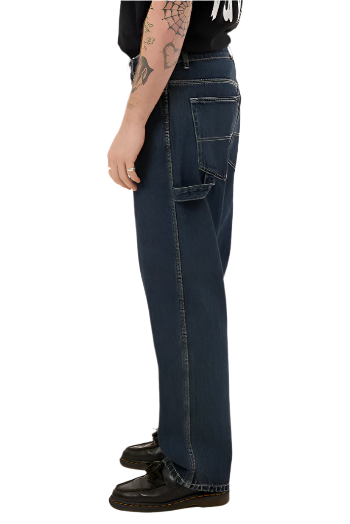 Person wearing dark blue jeans on a white background