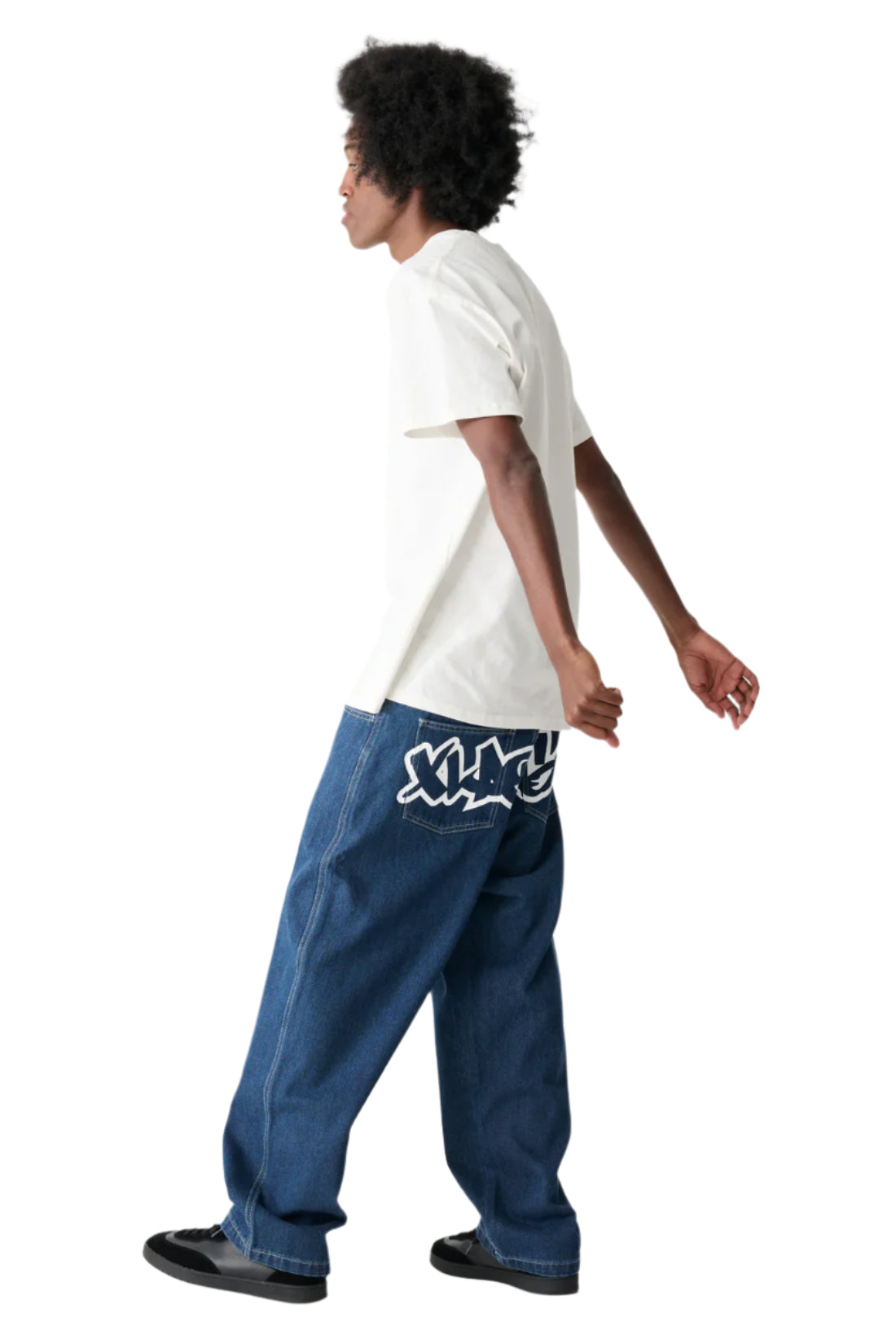 Person wearing a white t-shirt and blue jeans with a logo on a white background