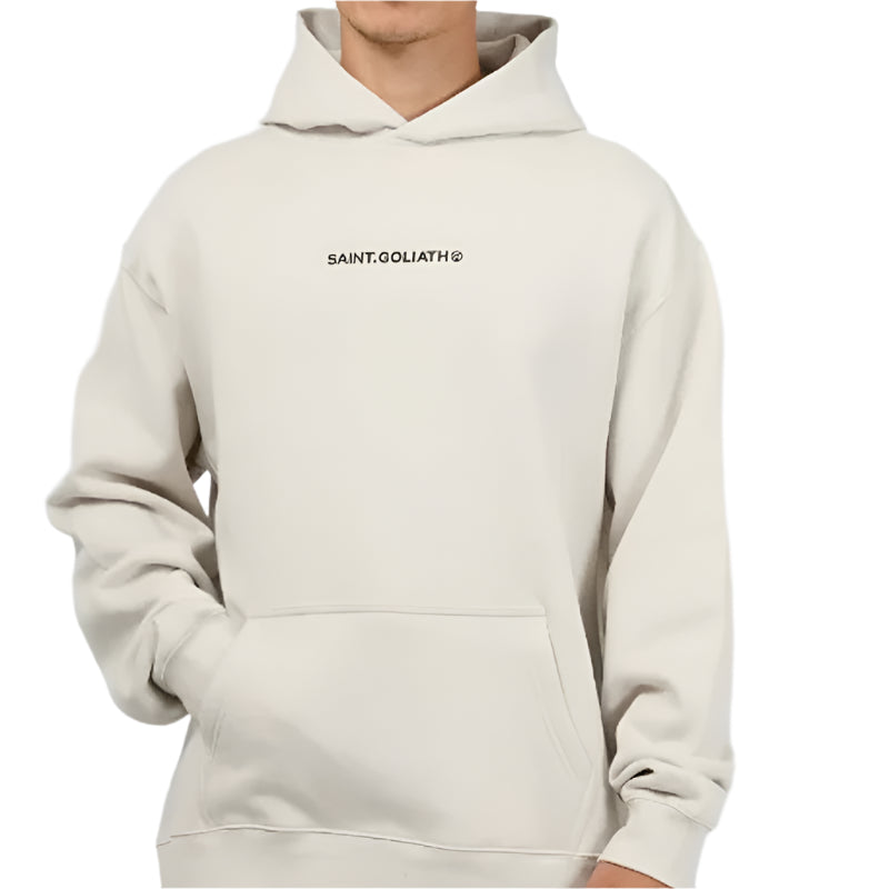 Person wearing a beige hoodie with a brand logo on a light gray background