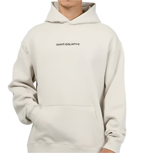 Person wearing a beige hoodie with a brand logo on a light gray background